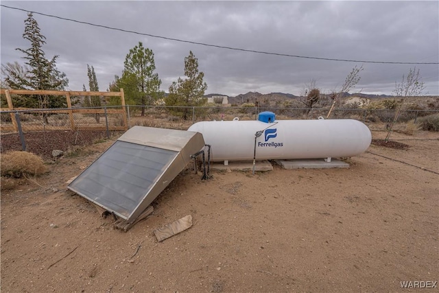 entry to storm shelter featuring fence and a mountain view