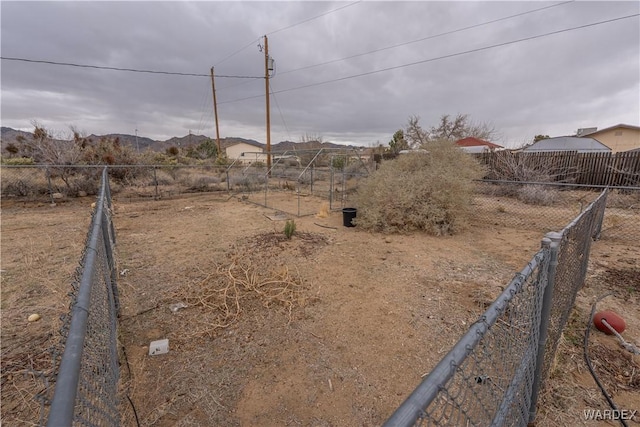 view of yard with a fenced backyard and a mountain view