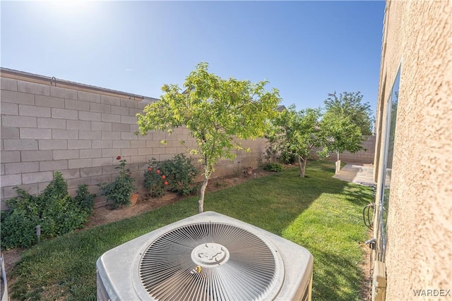 view of yard with a fenced backyard and cooling unit