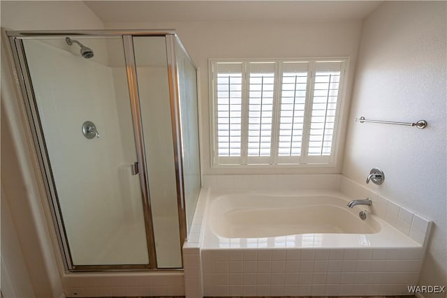 bathroom with a garden tub and a stall shower