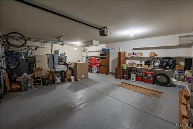 garage featuring strapped water heater and a garage door opener