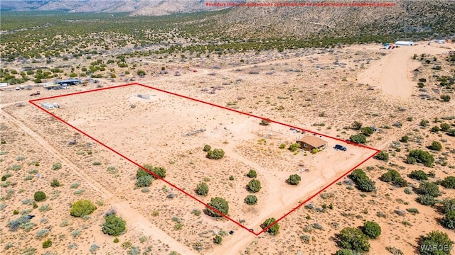 bird's eye view featuring a mountain view, a desert view, and a rural view