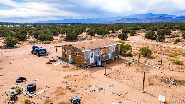 drone / aerial view featuring a desert view and a mountain view