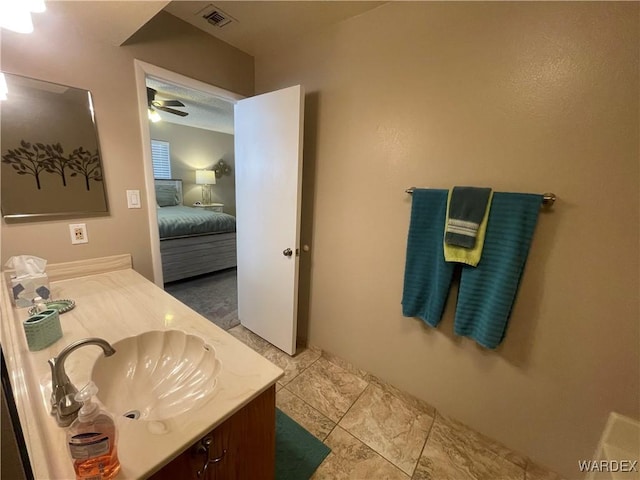 ensuite bathroom featuring ceiling fan, vanity, connected bathroom, and visible vents