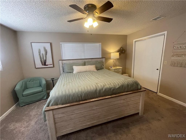 bedroom featuring baseboards, visible vents, ceiling fan, a textured ceiling, and dark carpet