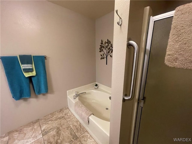 bathroom with a shower with door and a bath