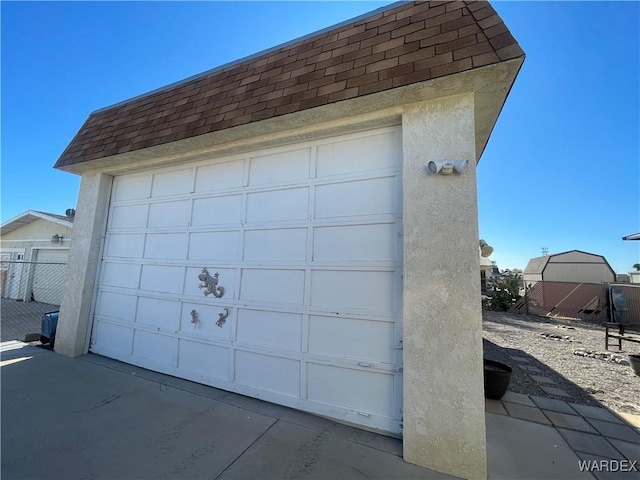 garage with fence