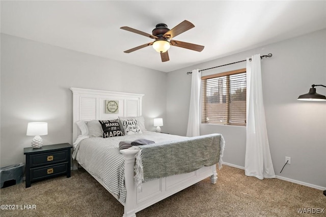bedroom with ceiling fan, carpet flooring, and baseboards