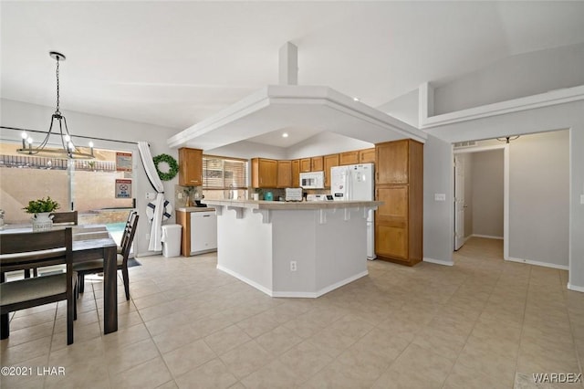 kitchen with a chandelier, white appliances, vaulted ceiling, and brown cabinetry