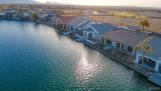 drone / aerial view with a water view and a residential view