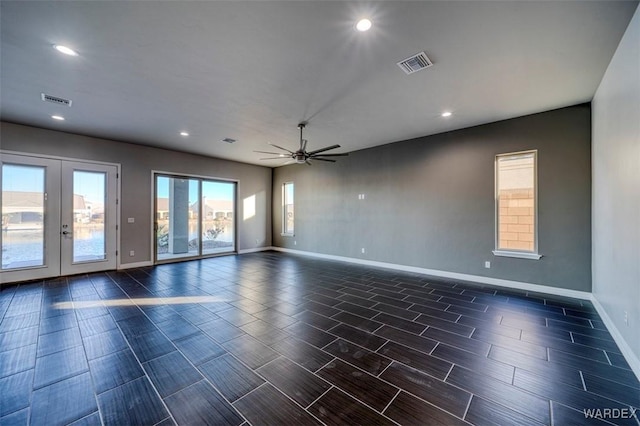 spare room with baseboards, french doors, visible vents, and a ceiling fan