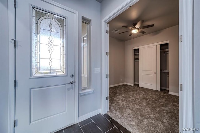 foyer entrance featuring a ceiling fan, visible vents, and baseboards