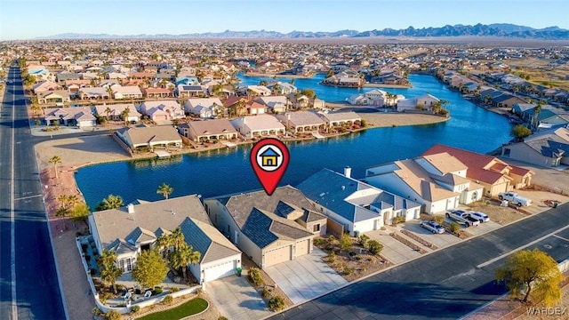 birds eye view of property with a residential view and a water and mountain view