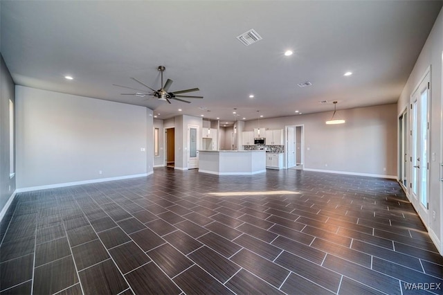 unfurnished living room featuring recessed lighting, visible vents, a ceiling fan, wood tiled floor, and baseboards