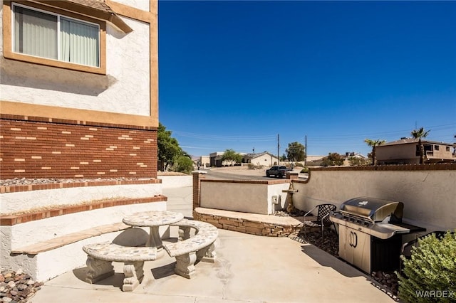 view of patio / terrace with grilling area and fence