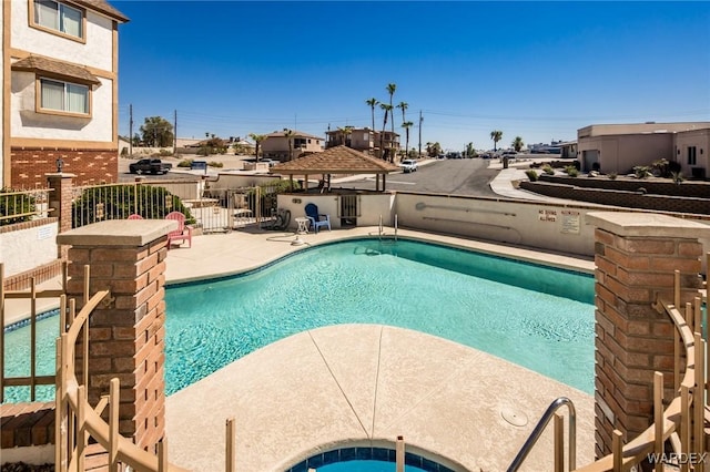 pool featuring a patio and fence