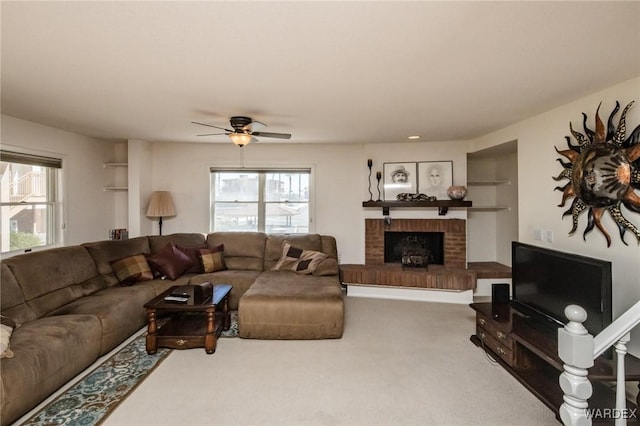 living room with carpet, a fireplace, and a ceiling fan