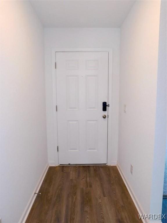 entryway featuring dark wood-style floors and baseboards