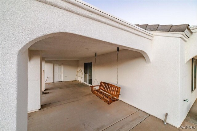 exterior space with a patio area and stucco siding