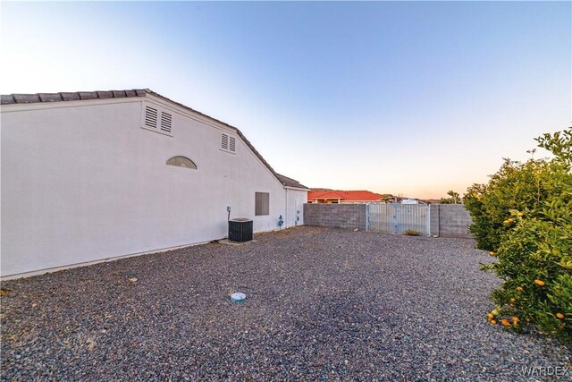 view of yard featuring central air condition unit and a fenced backyard