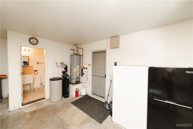 misc room with water heater and unfinished concrete floors