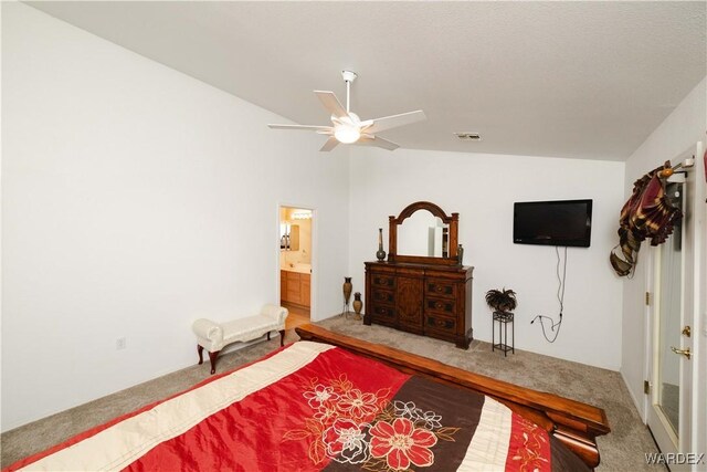 bedroom with carpet floors, lofted ceiling, visible vents, a ceiling fan, and connected bathroom