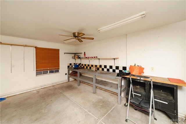 interior space featuring ceiling fan and a workshop area