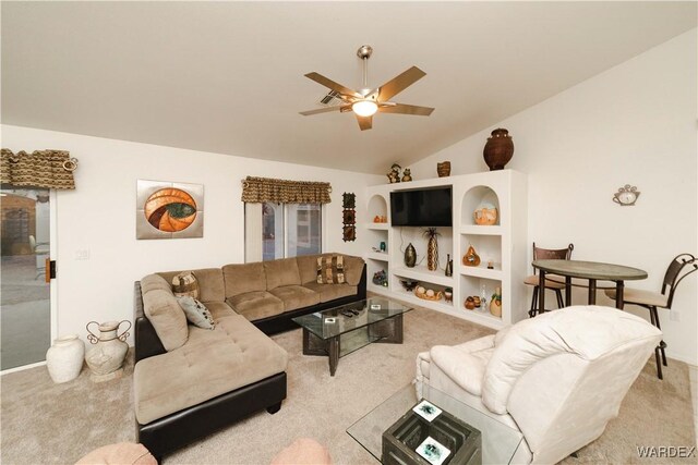 living area with carpet flooring, vaulted ceiling, and ceiling fan