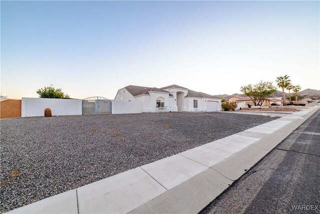 view of front of home featuring an attached garage, fence, and a residential view