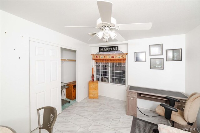 office area featuring marble finish floor and a ceiling fan