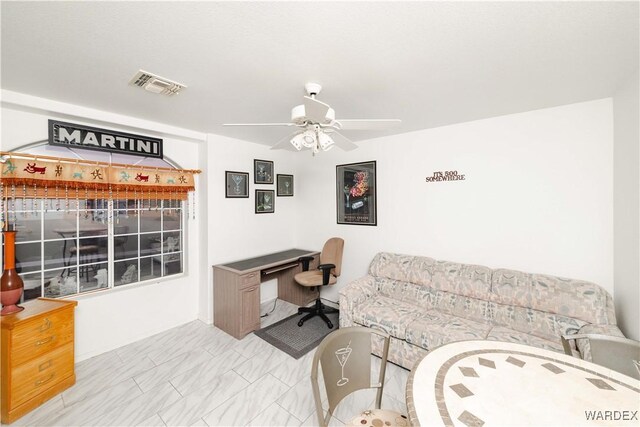 home office featuring marble finish floor, visible vents, and a ceiling fan