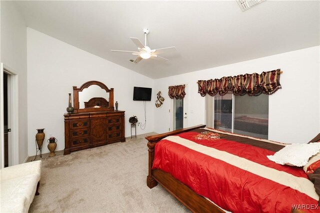 carpeted bedroom with lofted ceiling, visible vents, and a ceiling fan