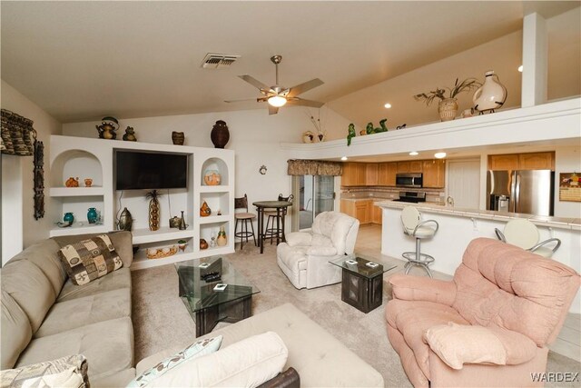 living room featuring light colored carpet, lofted ceiling, visible vents, and ceiling fan