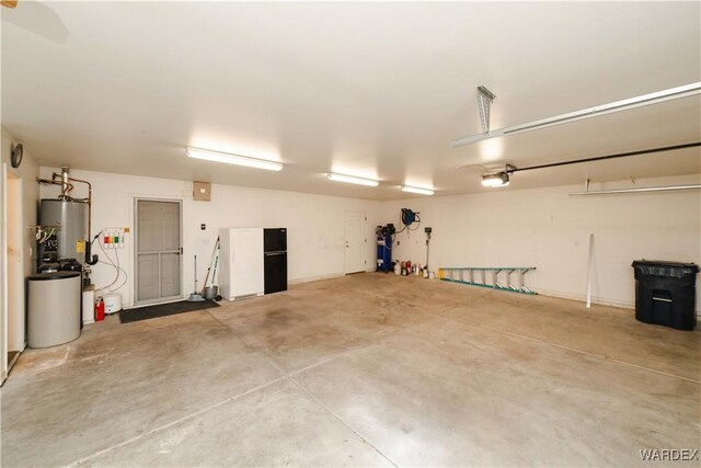 garage with water heater and a garage door opener