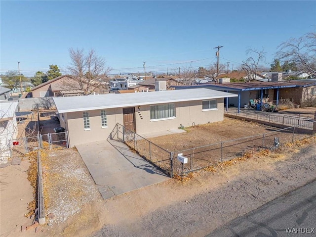 ranch-style house featuring a fenced front yard, a gate, and stucco siding