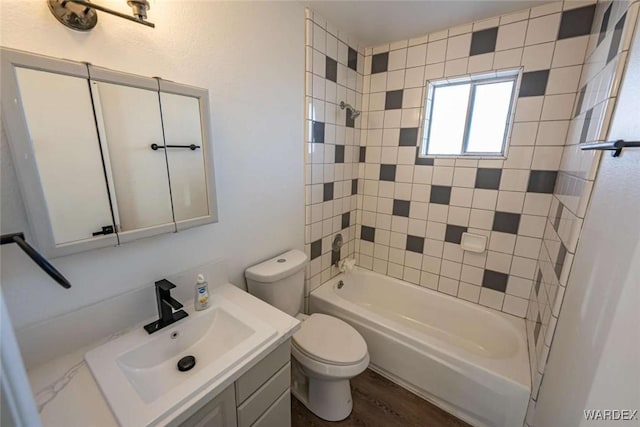 full bathroom with washtub / shower combination, vanity, toilet, and wood finished floors