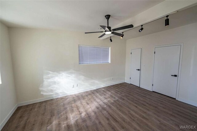 unfurnished bedroom with dark wood-style flooring, a ceiling fan, and baseboards