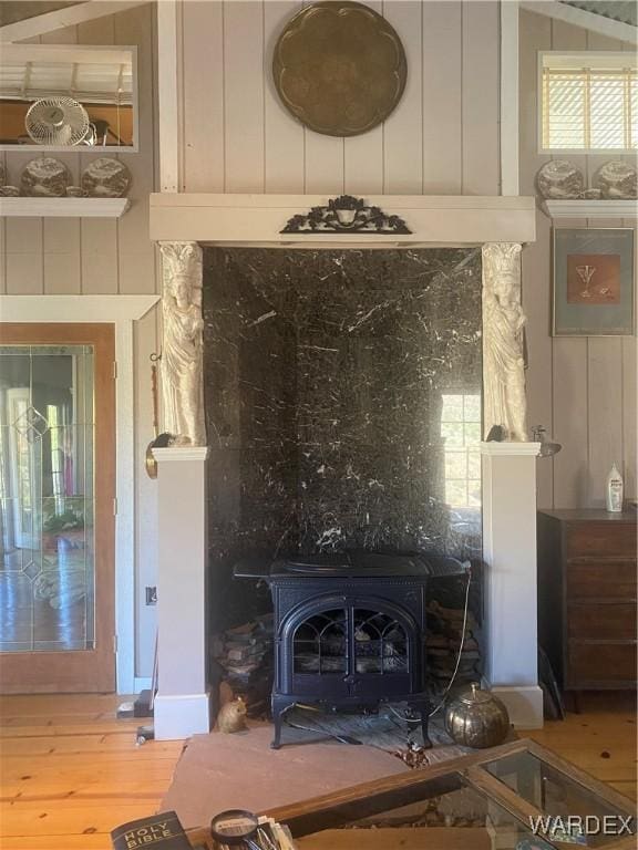 room details featuring a wood stove and wood finished floors