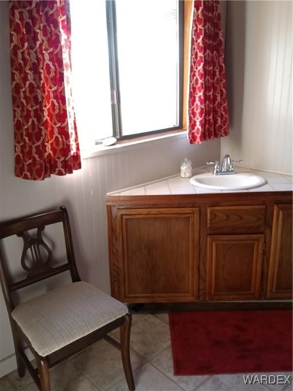 bathroom featuring tile patterned flooring and vanity