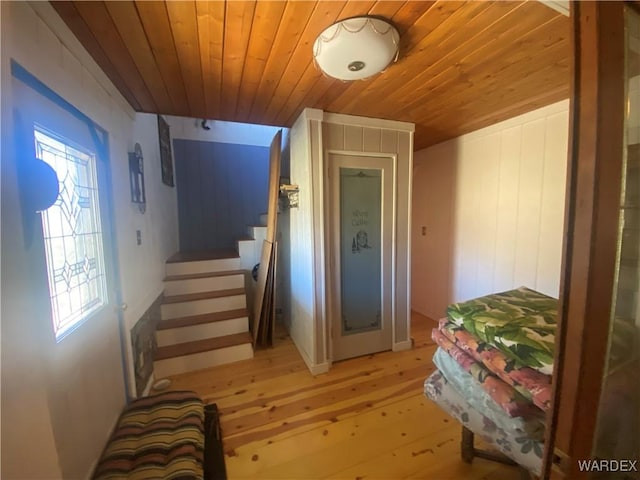 interior space featuring stairs, wood ceiling, and light wood-style floors