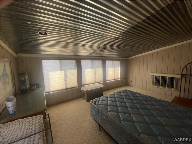 carpeted bedroom with wood walls