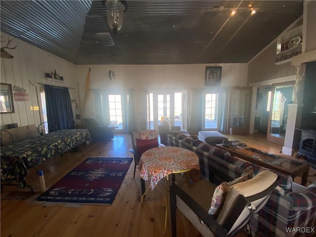 living room with high vaulted ceiling and wood finished floors