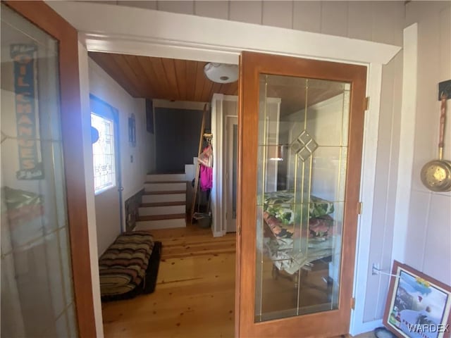 doorway with stairway and wood finished floors