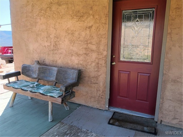 entrance to property featuring stucco siding