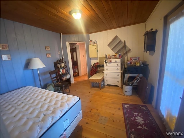 bedroom with wooden ceiling and light wood finished floors