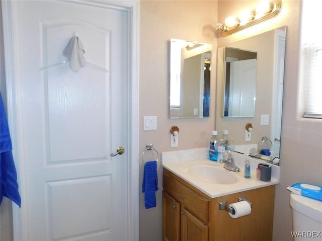 bathroom featuring vanity and toilet