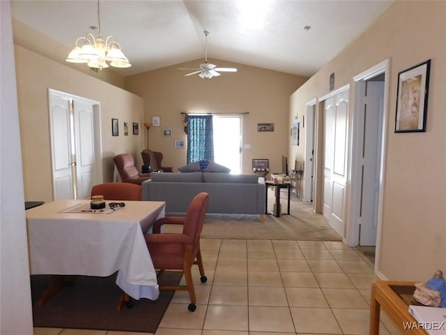 dining space with lofted ceiling, ceiling fan, and light tile patterned floors