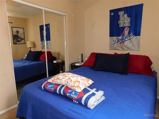 bedroom with a closet and baseboards