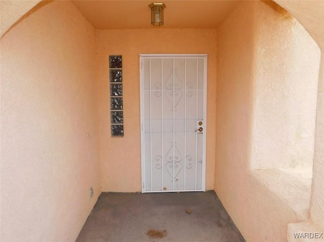 doorway to property with stucco siding