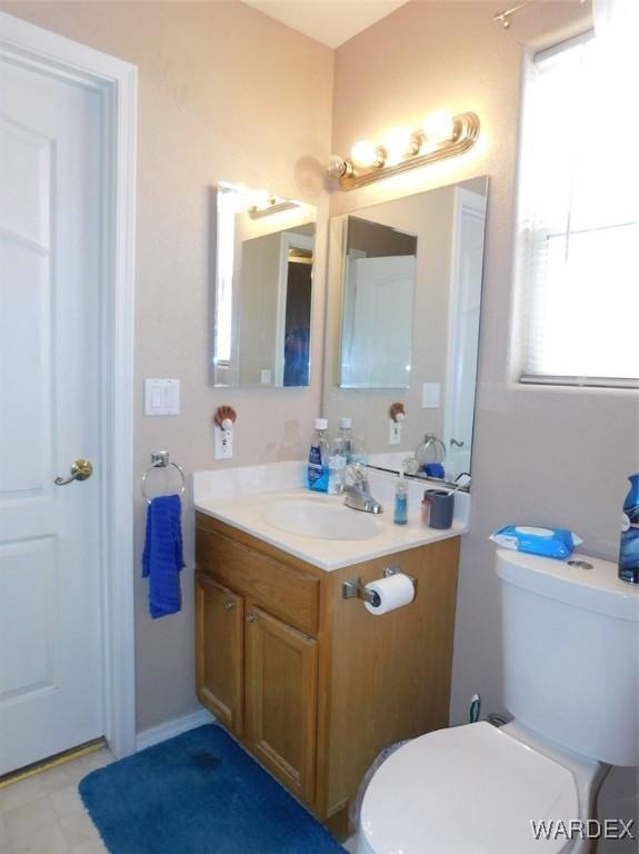 bathroom featuring vanity, toilet, and tile patterned floors